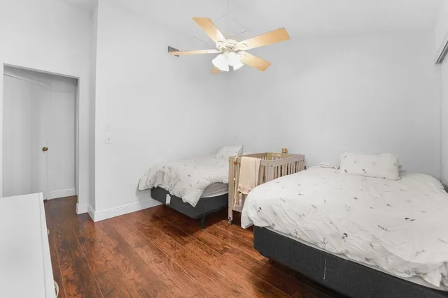 a bedroom with a bed and a ceiling fan