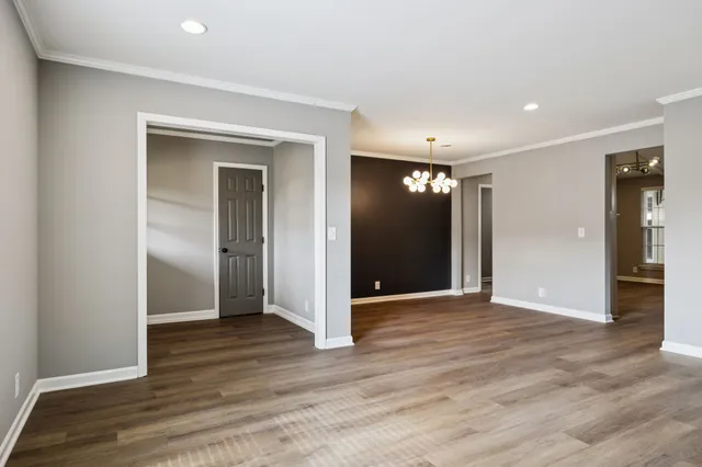 a view of hallway with wooden floor