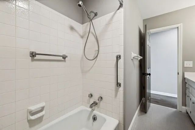 a bathroom with a bath tub with a shower
