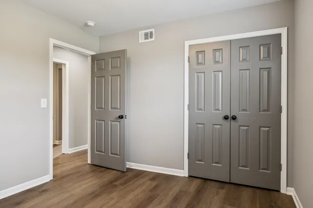 an empty room with wooden floor