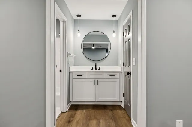 a bathroom with a sink a mirror and vanity