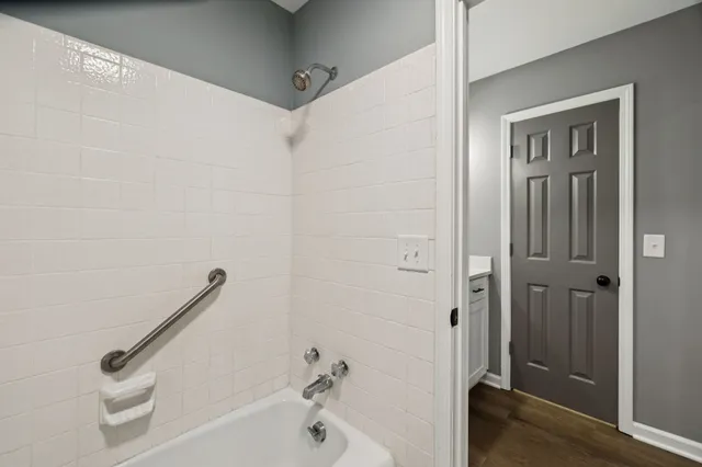 a bathroom with a tub and a shower