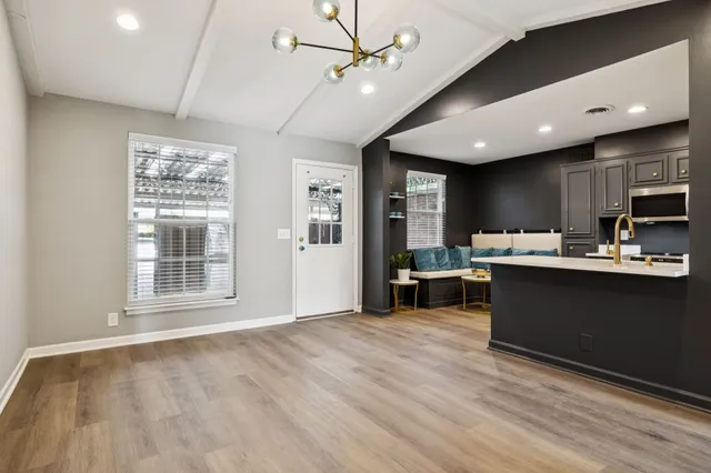 a living room with stainless steel appliances kitchen island granite countertop furniture a refrigerator a sink and a oven