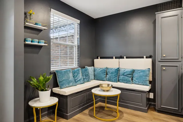 a balcony with table and chairs