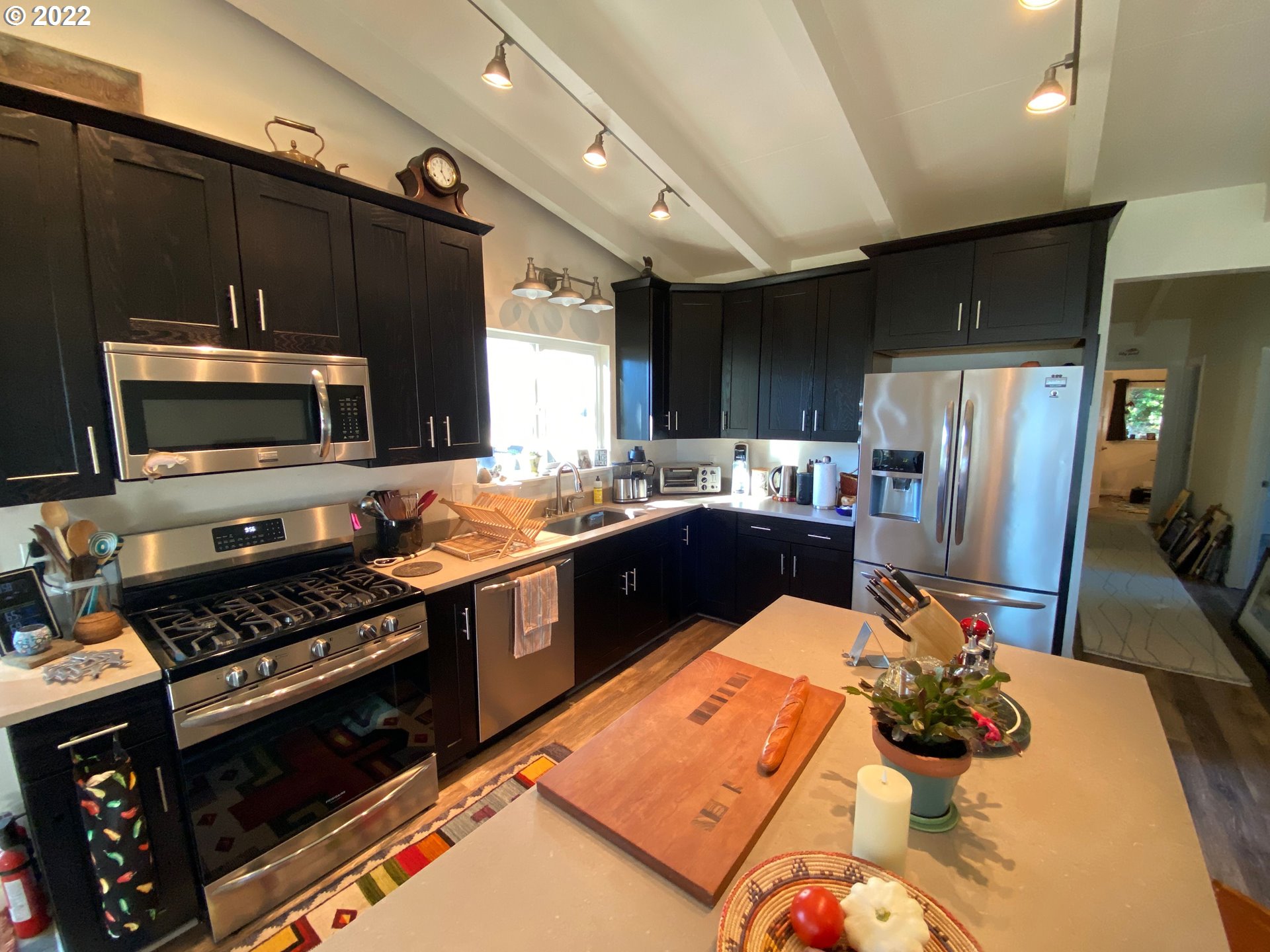95175 Marchmont Road Gold Beach, OR 97444 - Photo 12 of 32 a kitchen with granite countertop a refrigerator stove and microwave