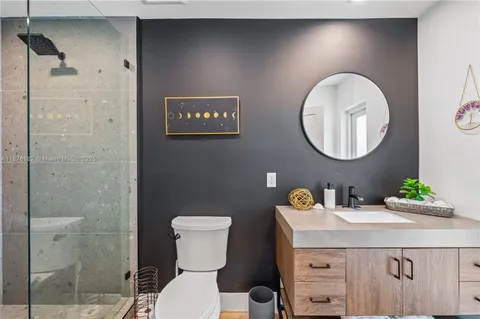 a bathroom with a sink mirror vanity and toilet