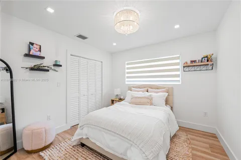 a bedroom with a bed and a chair