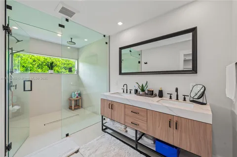 a bathroom with a double vanity sink and mirror