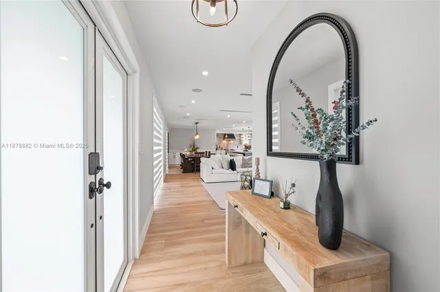 a dining hall with stainless steel appliances granite countertop a barbecue grill and a wooden floor