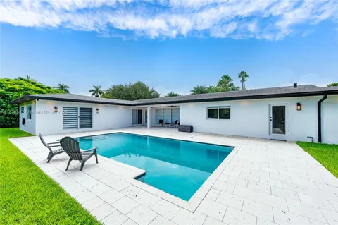 a view of house with swimming pool yard fire pit and outdoor seating