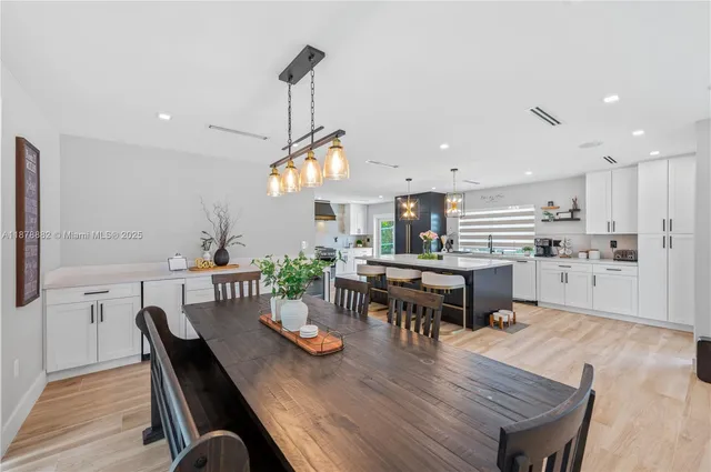 a kitchen with a table and chairs in it