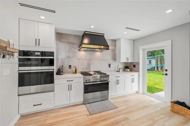 a kitchen with granite countertop a stove and a sink