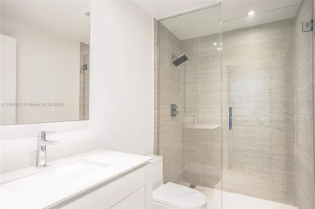 a bathroom with a sink toilet and shower