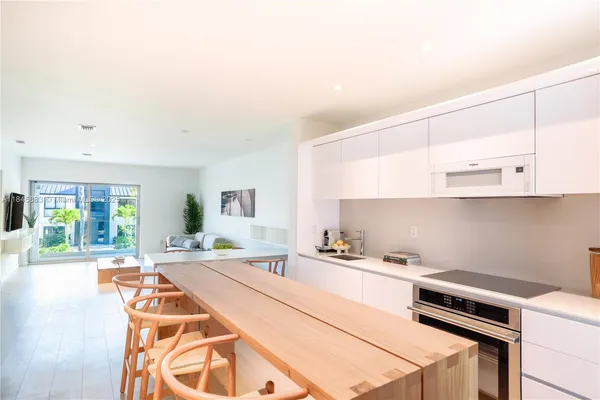 a kitchen with a stove a sink and a cabinets