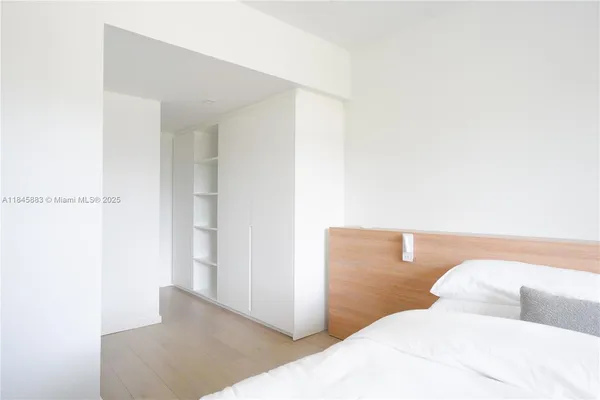 a bedroom with a bed and a night stand