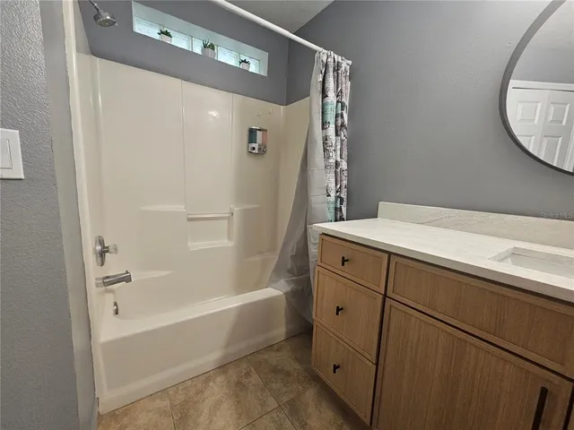 a bathroom with a bathtub and a sink