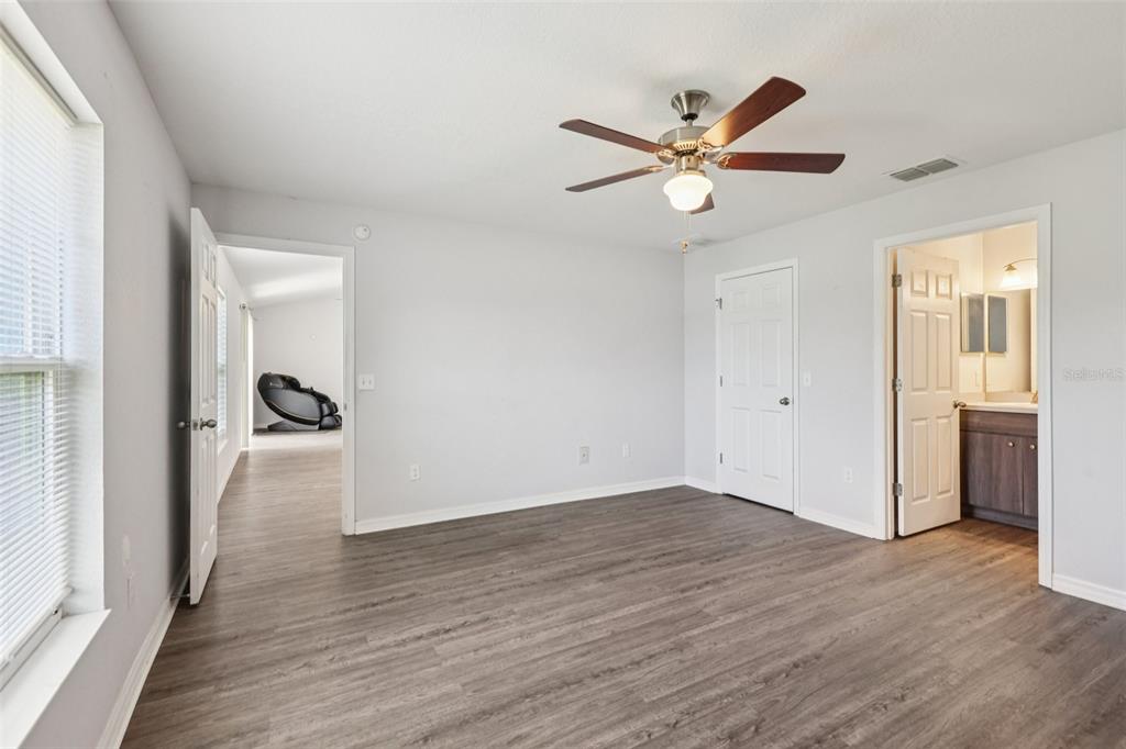 5 Laurel Pass Court Ocala, FL 34480 - Photo 12 of 23 a view of empty room with wooden floor and ceiling fan