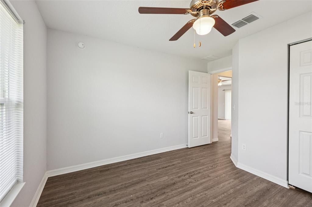 5 Laurel Pass Court Ocala, FL 34480 - Photo 16 of 23 a view of a room with wooden floor and a ceiling fan