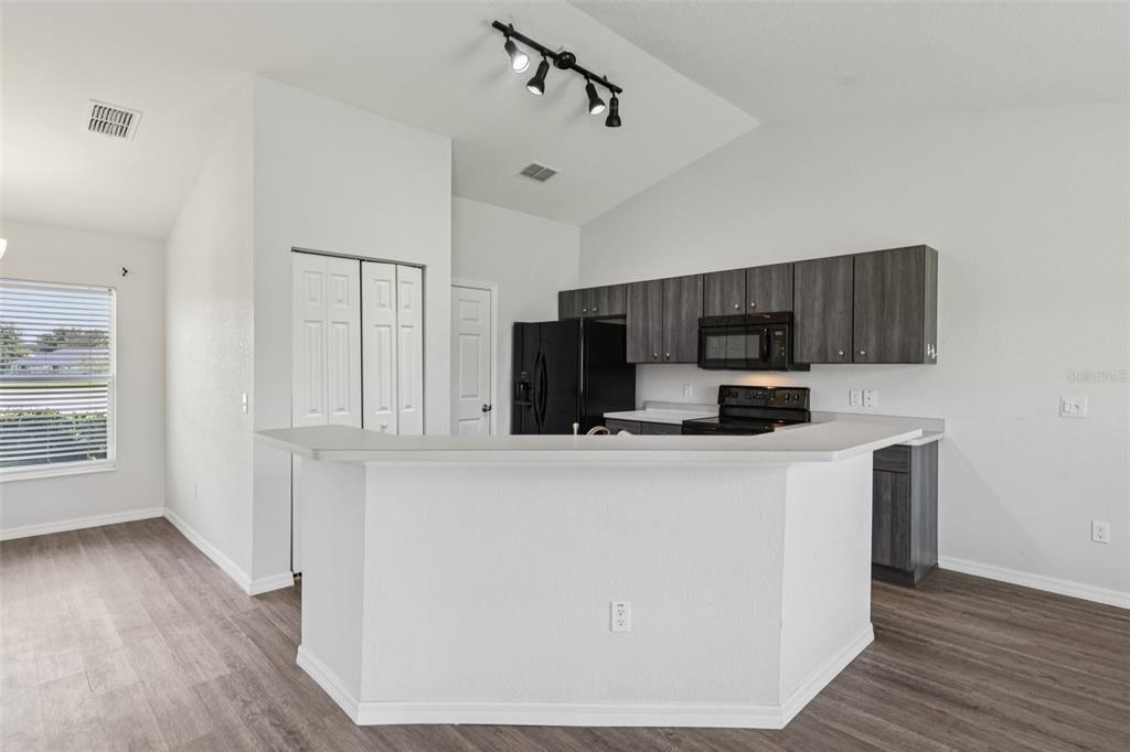 5 Laurel Pass Court Ocala, FL 34480 - Photo 7 of 23 a kitchen with stainless steel appliances a refrigerator and a stove top oven