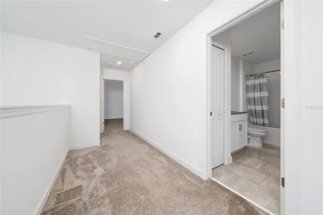 a spacious bathroom with a tub sink and mirror