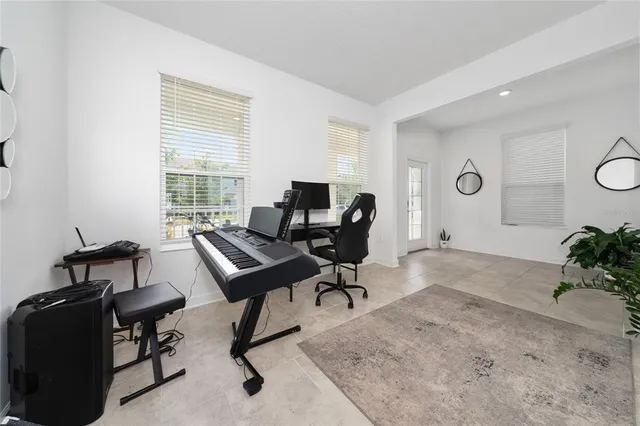 a kitchen with white cabinets and refrigerator