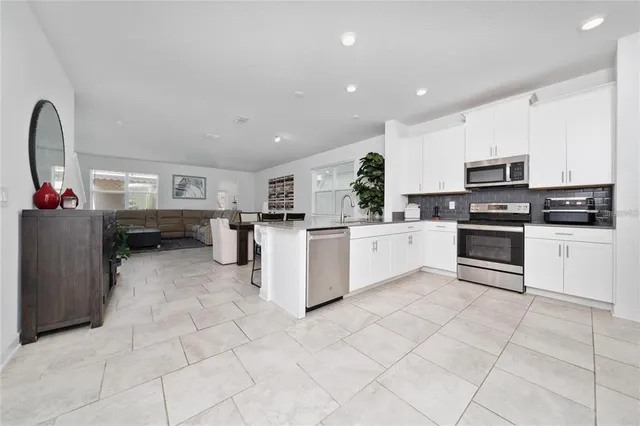 a kitchen with stainless steel appliances a refrigerator and a counter space