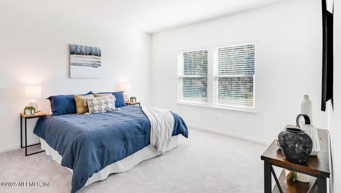 3199 Tupelo Loop Green Cove Springs, FL 32043 - Photo 19 of 26 a bedroom with a bed and wooden floor