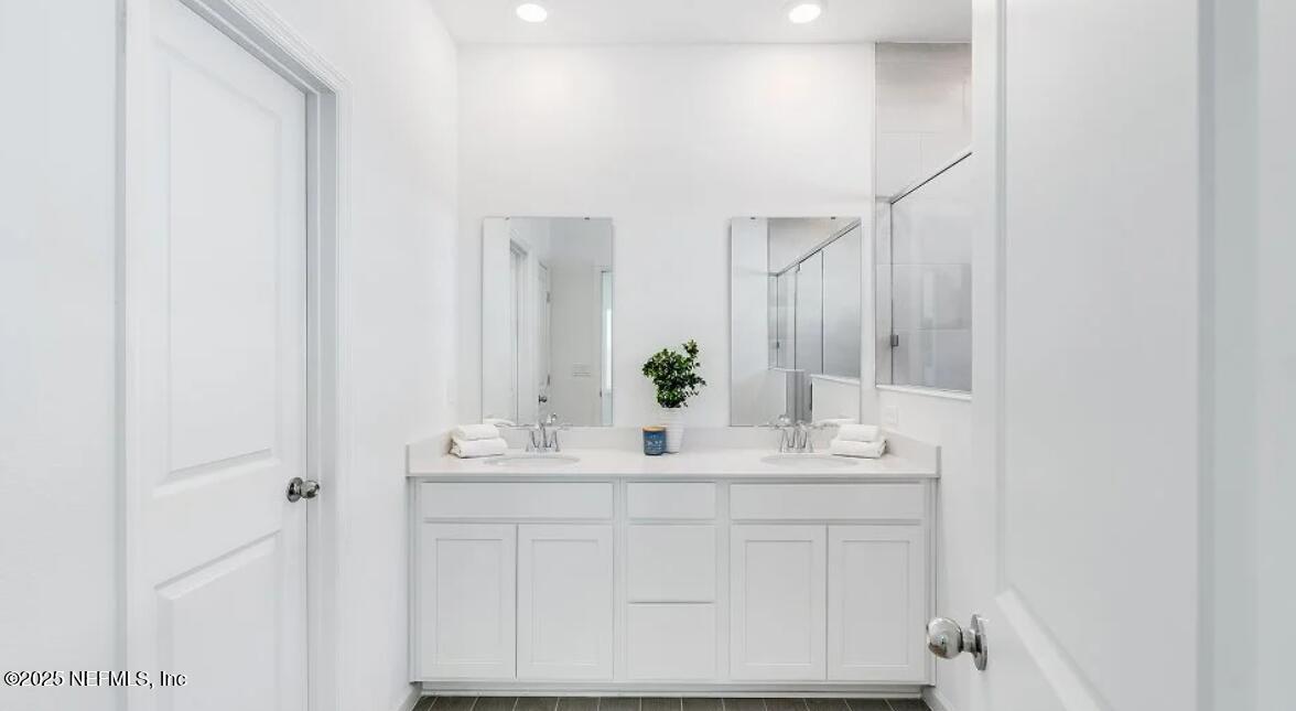 3199 Tupelo Loop Green Cove Springs, FL 32043 - Photo 20 of 26 a bathroom with a sink and a mirror