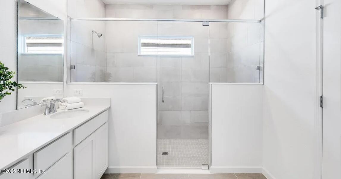3199 Tupelo Loop Green Cove Springs, FL 32043 - Photo 21 of 26 a bathroom with a sink and a mirror