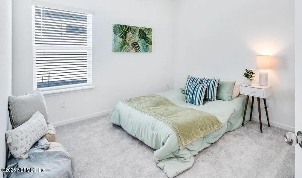 3199 Tupelo Loop Green Cove Springs, FL 32043 - Photo 22 of 26 a bedroom with a bed and a couch