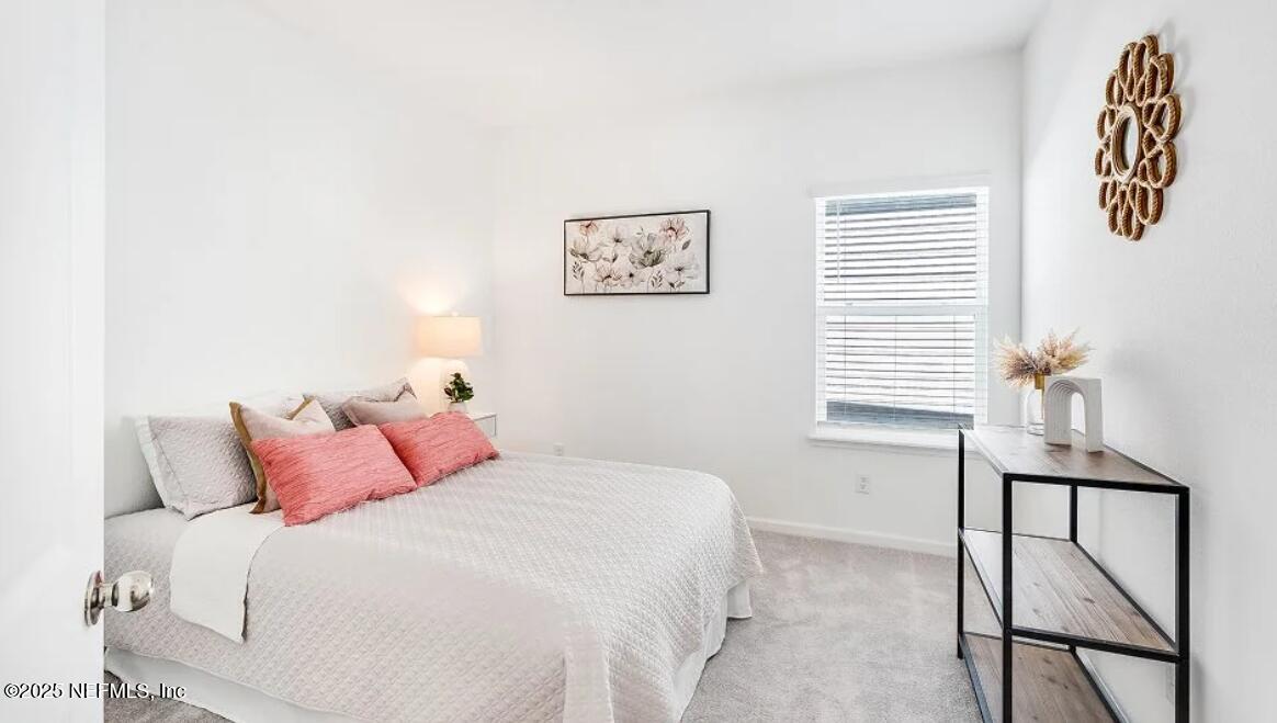 3199 Tupelo Loop Green Cove Springs, FL 32043 - Photo 23 of 26 a bedroom with a bed and a window