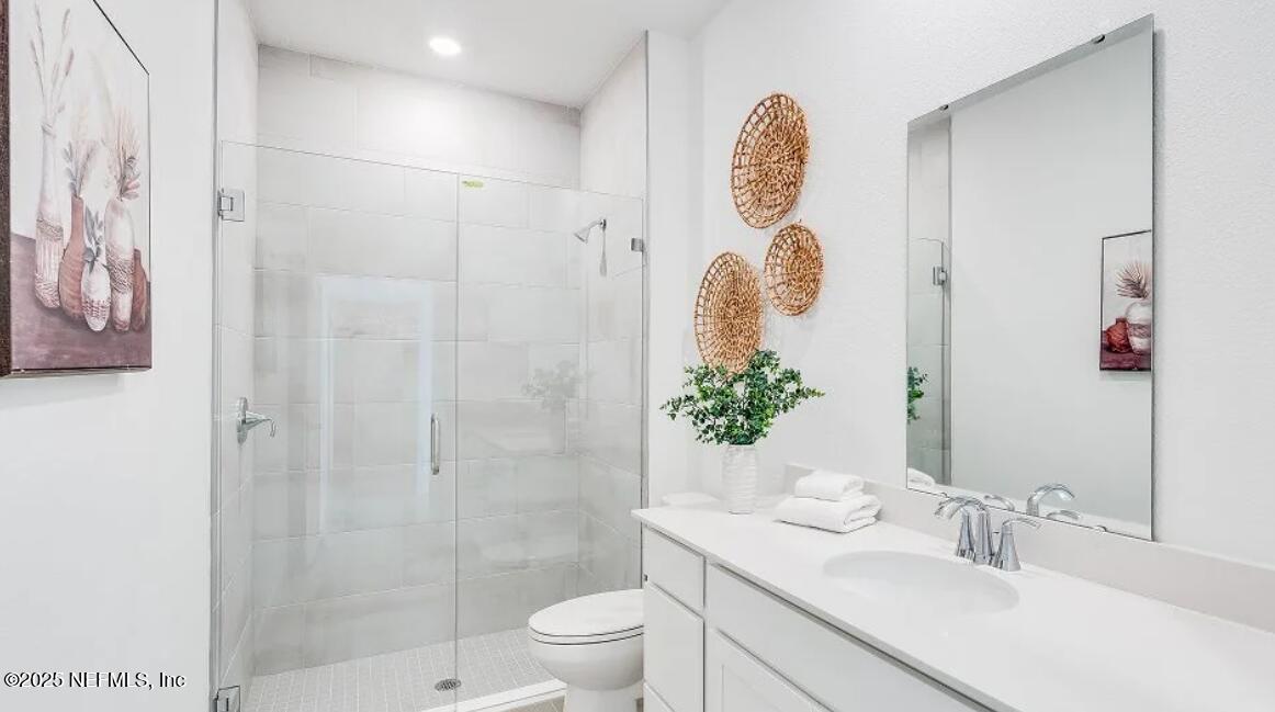 3199 Tupelo Loop Green Cove Springs, FL 32043 - Photo 25 of 26 a bathroom with a sink a toilet and shower