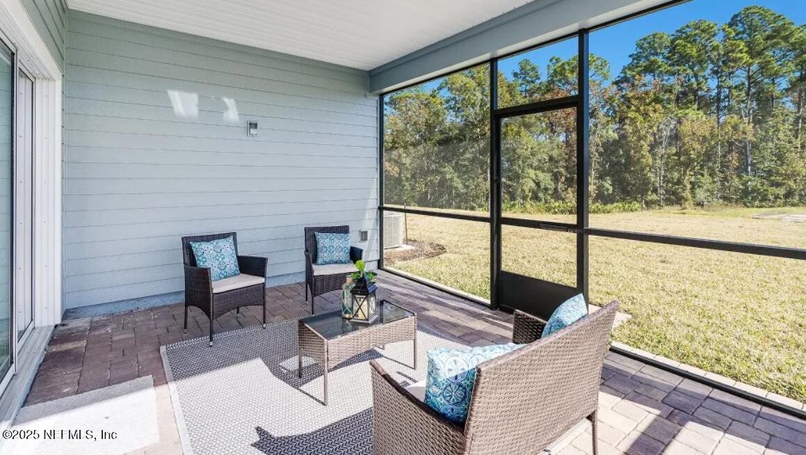 3199 Tupelo Loop Green Cove Springs, FL 32043 - Photo 26 of 26 a living room with furniture and a floor to ceiling window