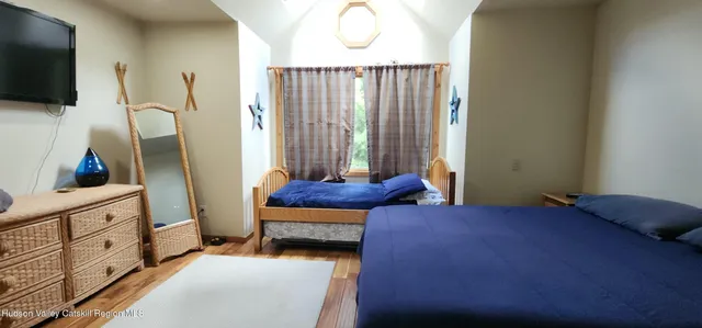 a living room with furniture a flat screen tv and a window