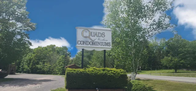 a view of a street with a building in the background