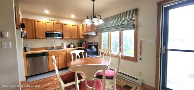 a kitchen with kitchen island granite countertop a refrigerator a sink a stove and cabinets