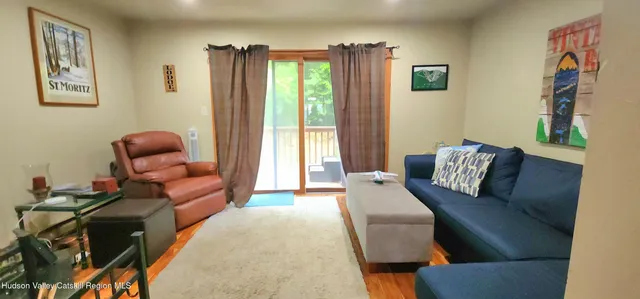 a bedroom with furniture and a large window