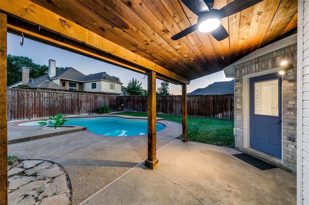 4532 Crown Ridge Drive Plano, TX 75024 - Photo 21 of 25 Covered outdoor living space featuring a wood plank ceiling and a ceiling fan with integrated lighting