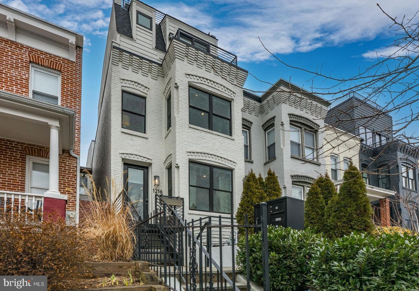 a front view of a building with a garden