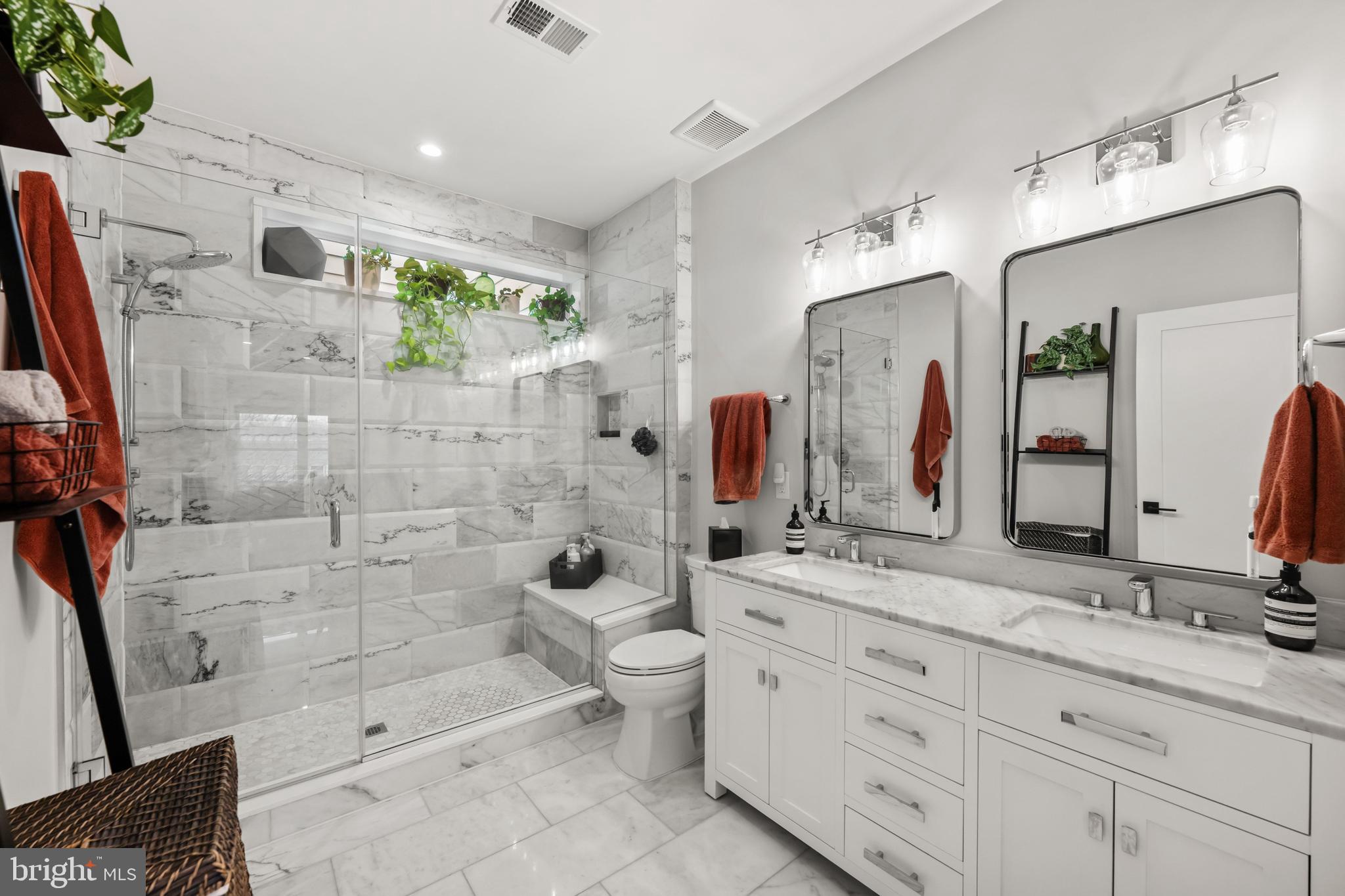 1216 I Street Northeast, Unit A Washington, DC 20002 - Photo 16 of 34 a bathroom with a double vanity sink toilet and shower
