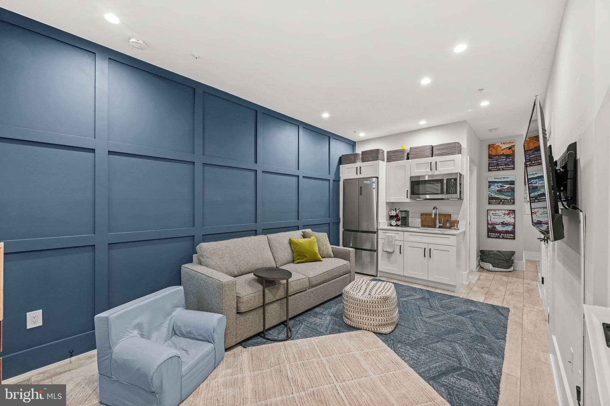 1216 I Street Northeast, Unit A Washington, DC 20002 - Photo 23 of 34 a living room with furniture and a book shelf