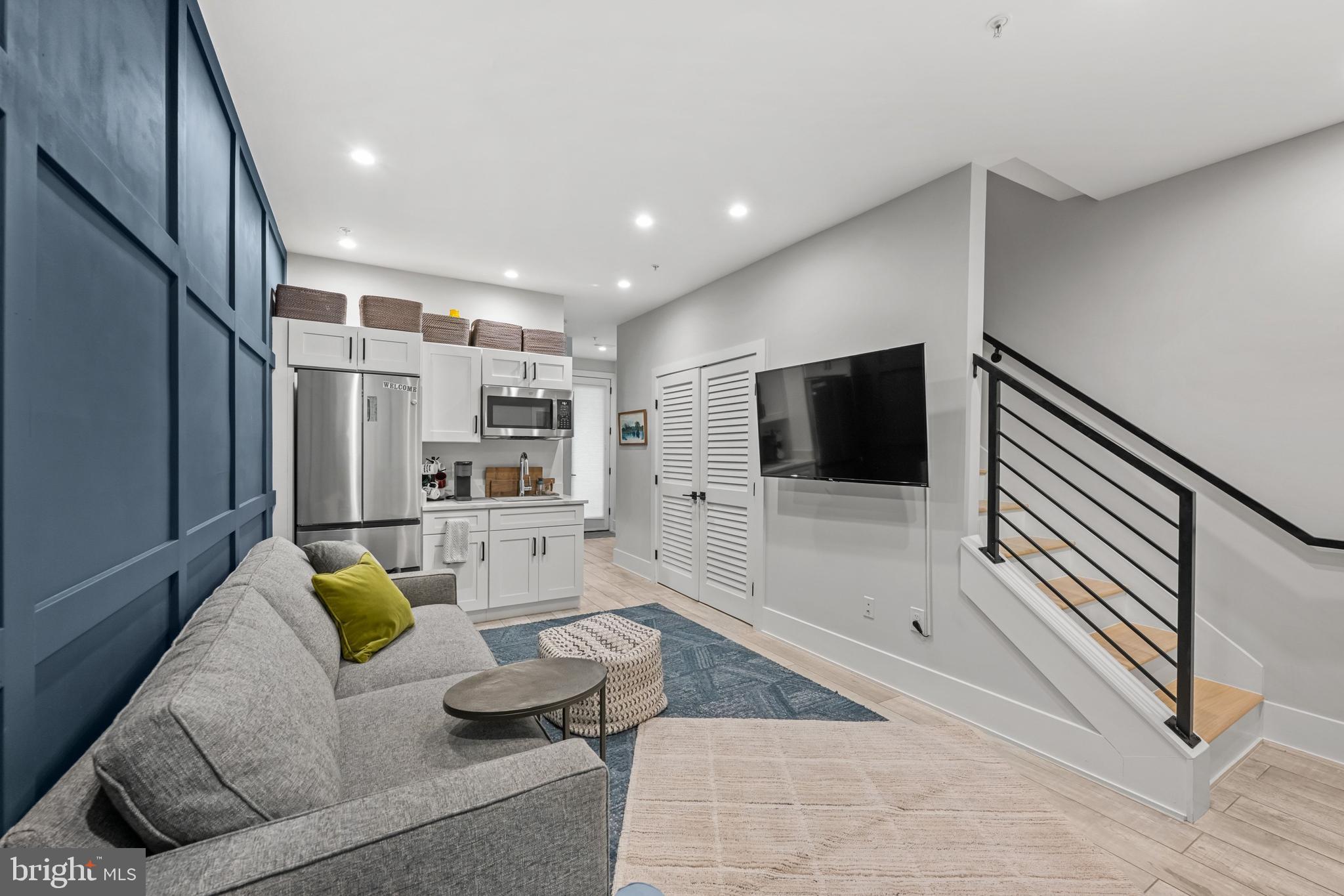 1216 I Street Northeast, Unit A Washington, DC 20002 - Photo 24 of 34 a living room with furniture and a flat screen tv