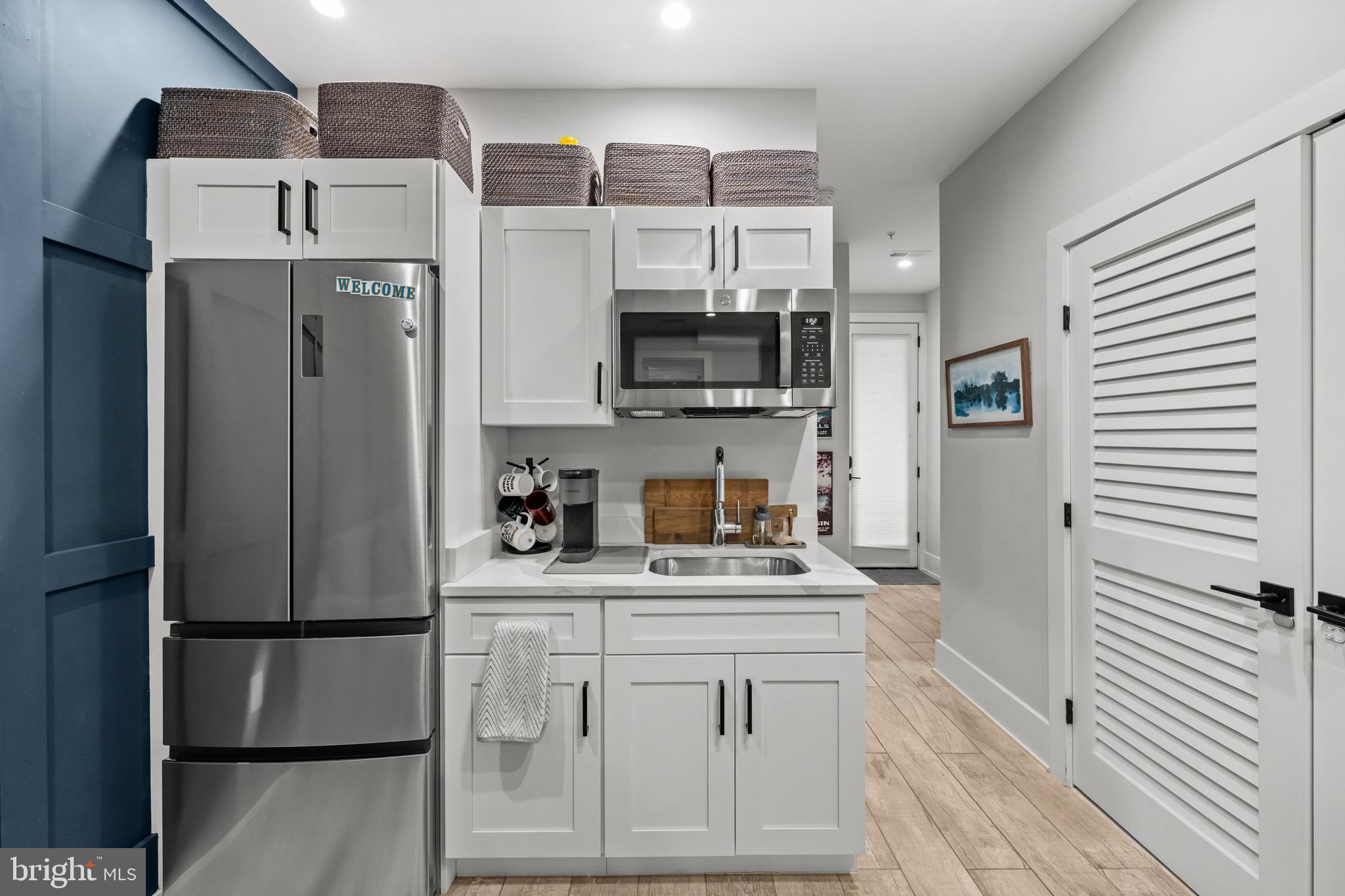 1216 I Street Northeast, Unit A Washington, DC 20002 - Photo 25 of 34 a kitchen with stainless steel appliances a refrigerator sink and cabinets