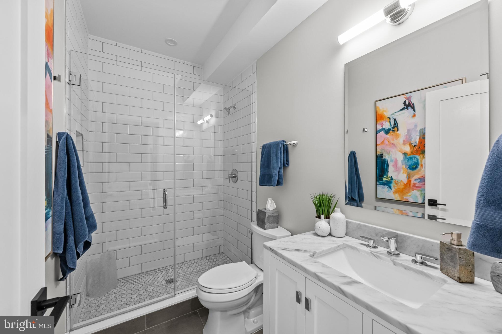 1216 I Street Northeast, Unit A Washington, DC 20002 - Photo 28 of 34 a bathroom with a sink toilet and shower