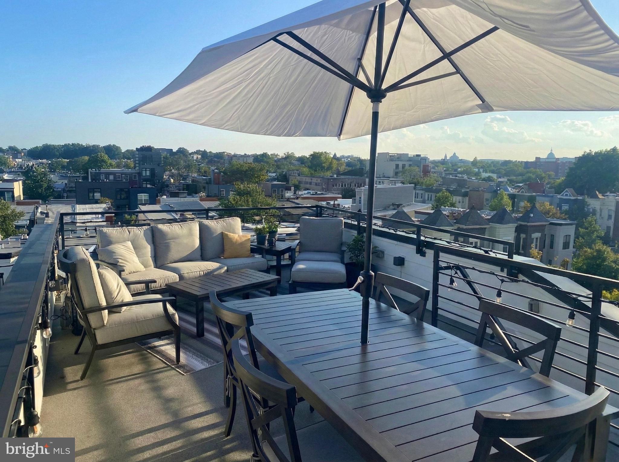 1216 I Street Northeast, Unit A Washington, DC 20002 - Photo 30 of 34 an outdoor sitting area with furniture and wooden floor
