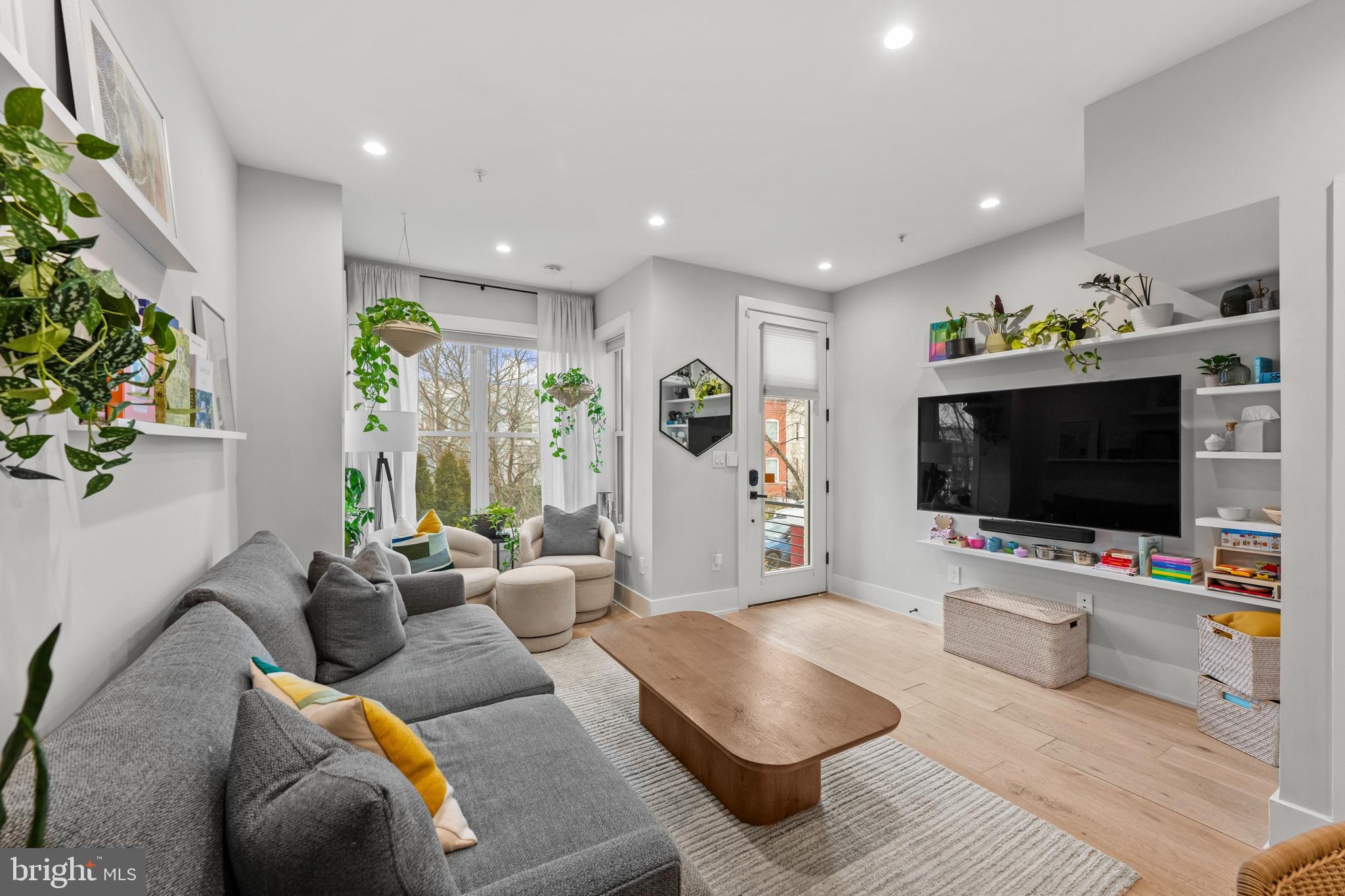 1216 I Street Northeast, Unit A Washington, DC 20002 - Photo 4 of 34 a living room with furniture and a flat screen tv