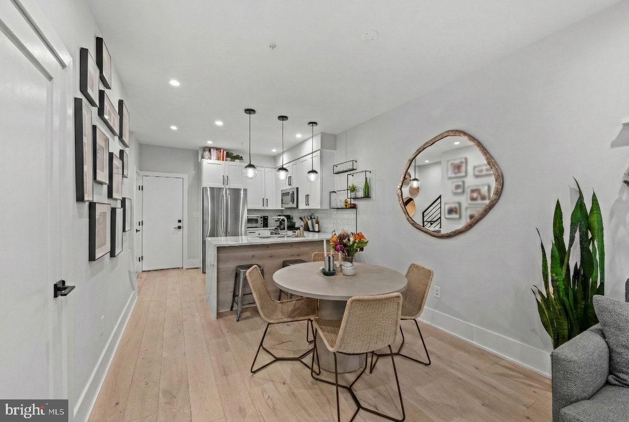 1216 I Street Northeast, Unit A Washington, DC 20002 - Photo 6 of 34 a dining room with furniture and a clock