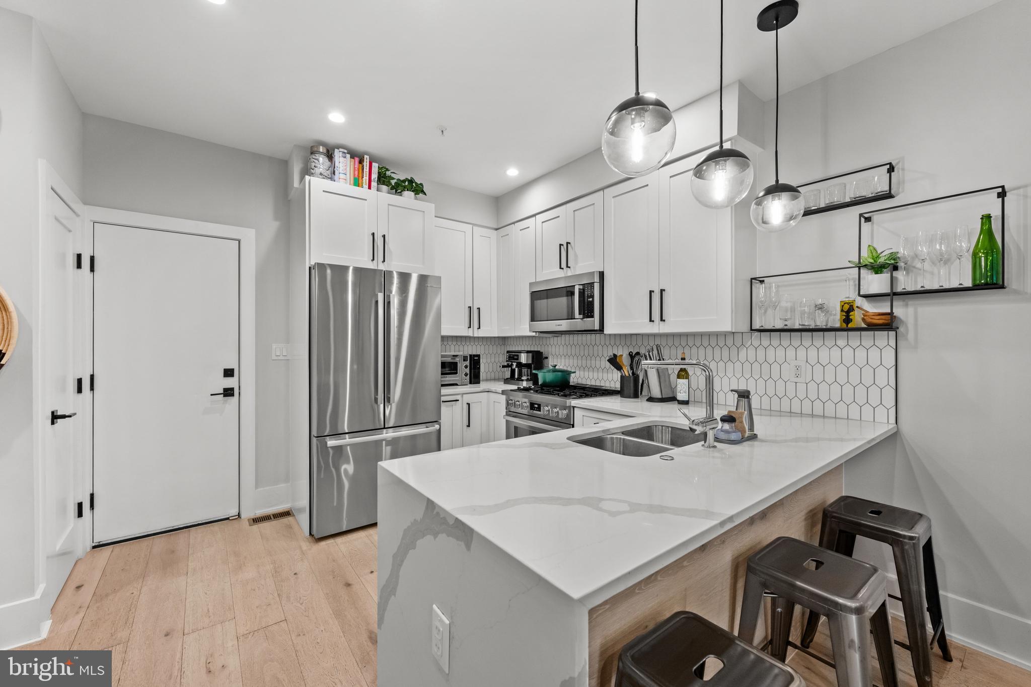 1216 I Street Northeast, Unit A Washington, DC 20002 - Photo 7 of 34 a kitchen with kitchen island a sink stove and refrigerator