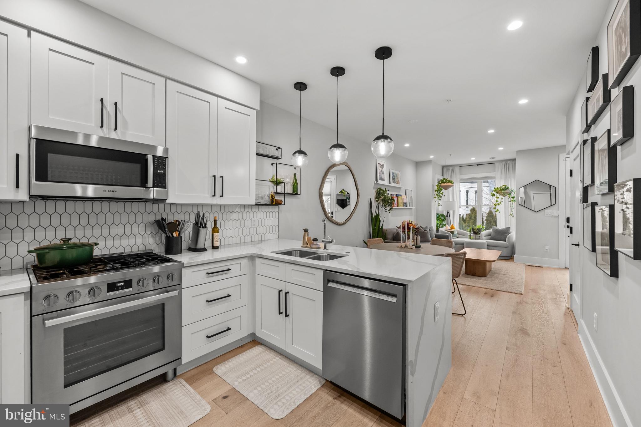 1216 I Street Northeast, Unit A Washington, DC 20002 - Photo 8 of 34 a kitchen with a sink stove and microwave