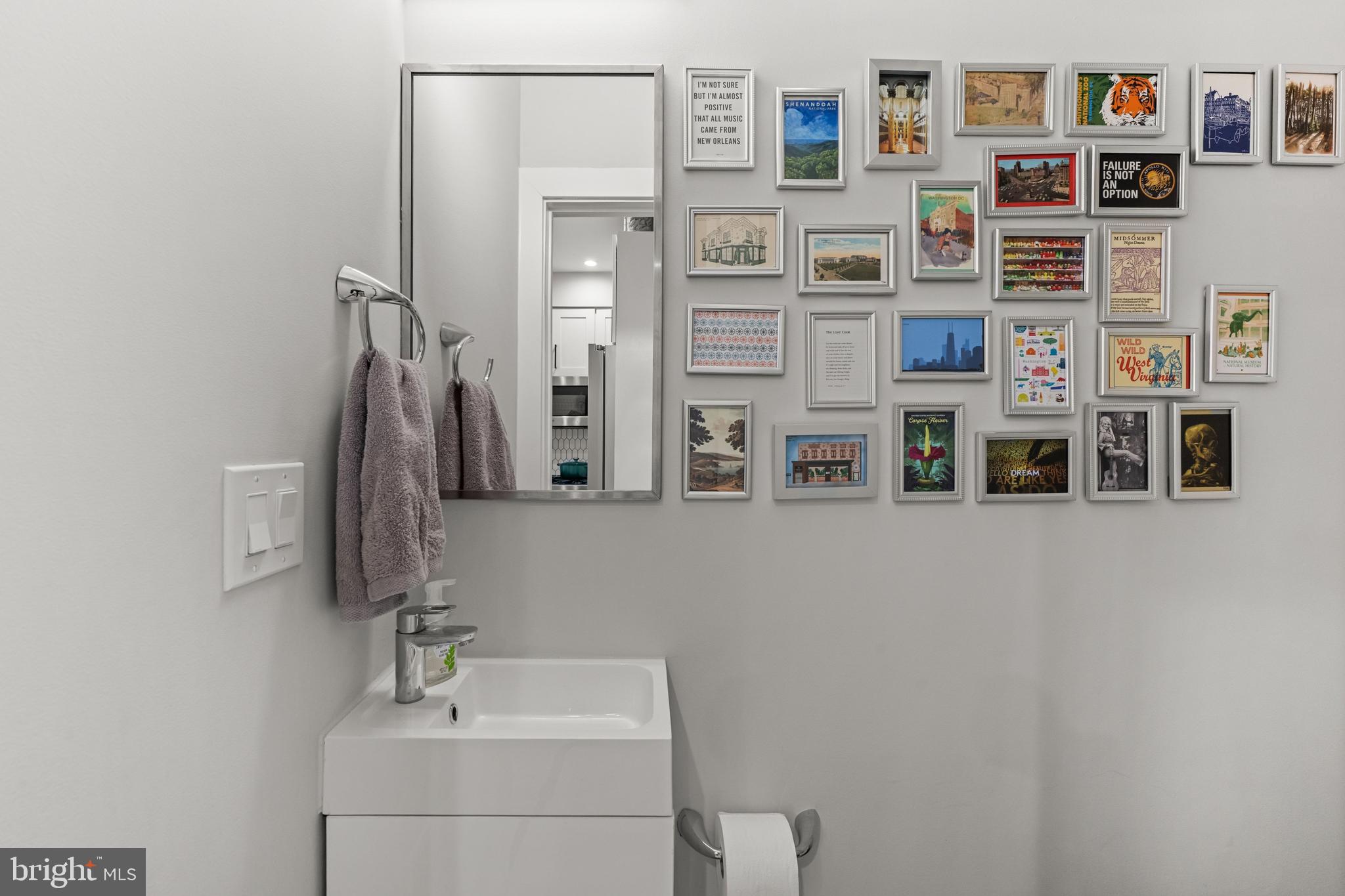 1216 I Street Northeast, Unit A Washington, DC 20002 - Photo 10 of 34 a bathroom with a double vanity sink and a mirror